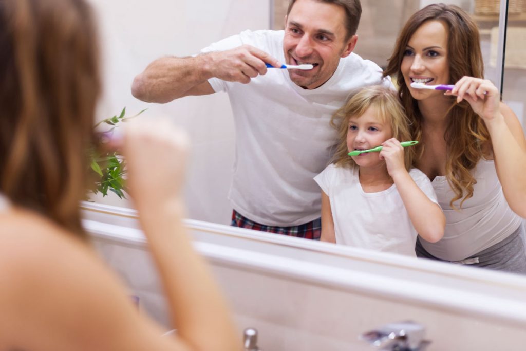 Familia cepillándose los dientes